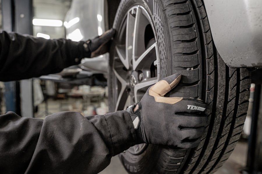 Mechanic checking Mercedes tyre and wheel at Maxim Motors